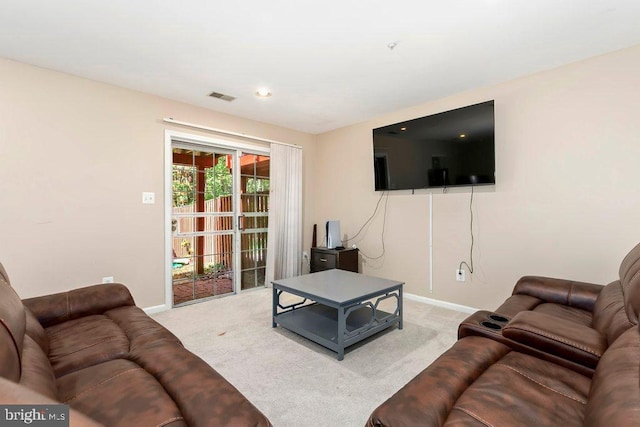 living area featuring visible vents, baseboards, and carpet floors