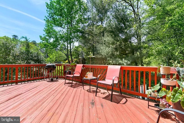 wooden terrace featuring area for grilling