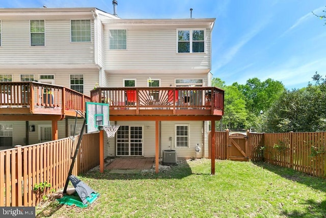 back of property featuring a wooden deck, a fenced backyard, and a gate