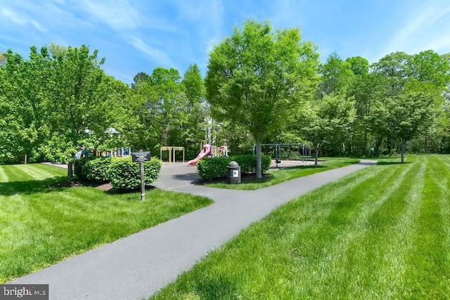 surrounding community with a yard and playground community
