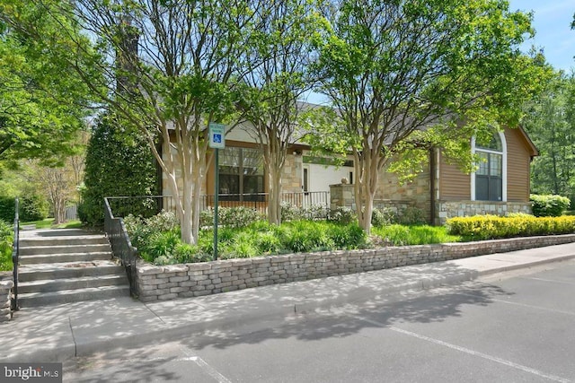 view of side of property with stone siding