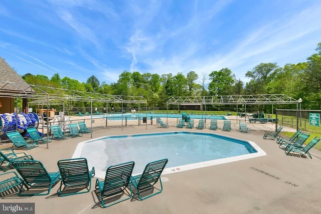 community pool featuring fence