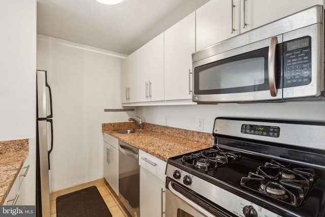 219 S 18th St Unit 1422, Philadelphia, PA 19103 - kitchen with a sink, white cabinets, stainless steel appliances, and baseboards