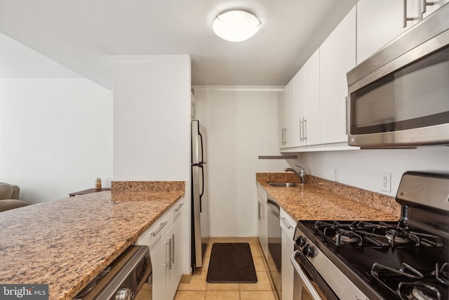 219 S 18th St Unit 1422, Philadelphia, PA 19103 - kitchen featuring appliances with stainless steel finishes, light stone countertops, white cabinets, and a sink