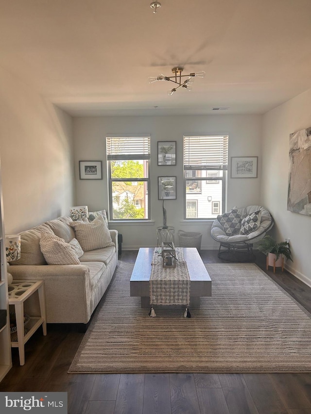 45952 Swallow Ter, Sterling, VA 20165 - living room featuring healthy amount of natural light, hardwood / wood-style floors, and baseboards