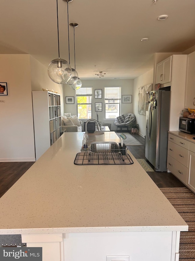 45952 Swallow Ter, Sterling, VA 20165 - kitchen with stainless steel refrigerator with ice dispenser, open floor plan, a kitchen island, light stone counters, and dark wood-style floors