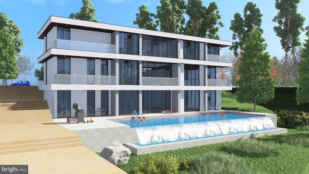 back of property featuring a patio, an empty pool, and stucco siding