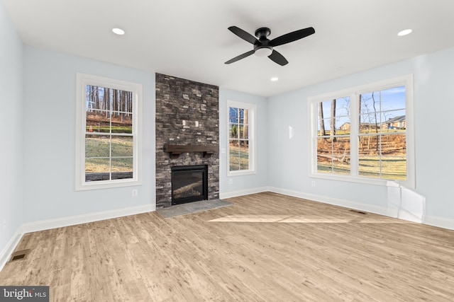 W Main Blvd, Lutherville Timonium, MD 21093 - unfurnished living room featuring a ceiling fan, visible vents, plenty of natural light, and wood finished floors