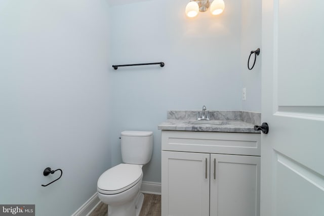 W Main Blvd, Lutherville Timonium, MD 21093 - half bath with vanity, baseboards, toilet, and wood finished floors