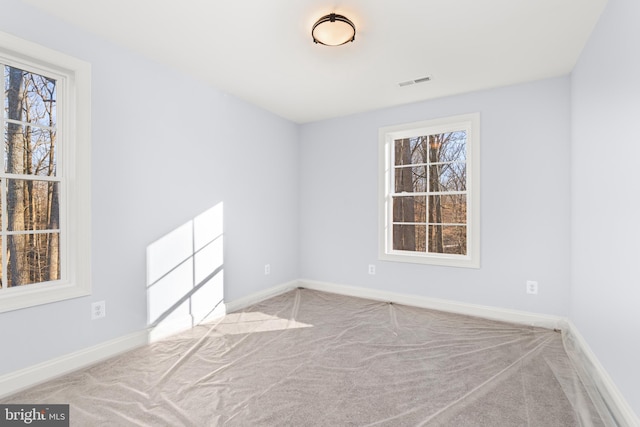 W Main Blvd, Lutherville Timonium, MD 21093 - carpeted empty room featuring a healthy amount of sunlight, baseboards, and visible vents