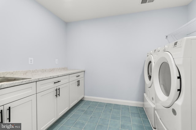 W Main Blvd, Lutherville Timonium, MD 21093 - washroom featuring baseboards, tile patterned floors, cabinet space, and washing machine and clothes dryer