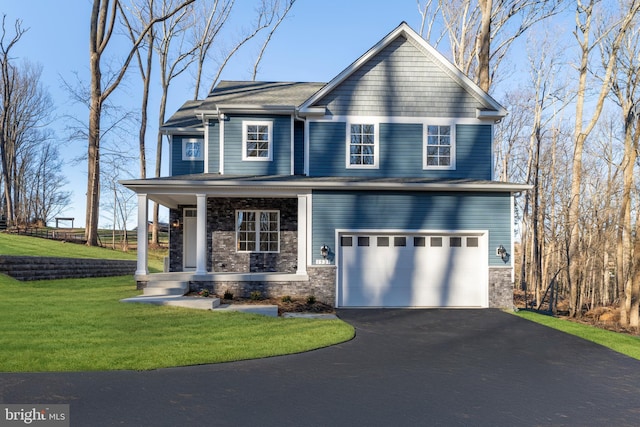 W Main Blvd, Lutherville Timonium, MD 21093 - view of front facade featuring covered porch, driveway, a front yard, an attached garage, and stone siding