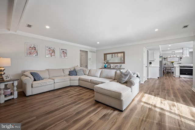 living room featuring beamed ceiling, recessed lighting, wood finished floors, and visible vents