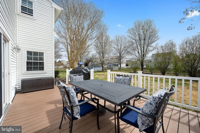 deck with a yard, outdoor dining space, and a fenced backyard