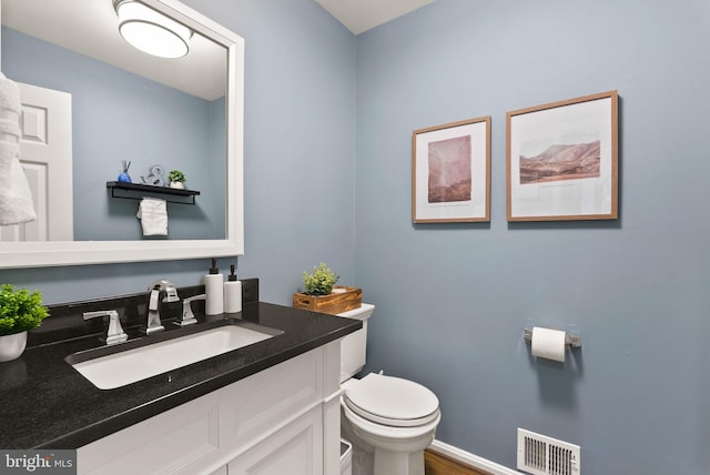 bathroom featuring visible vents, wood finished floors, toilet, and vanity