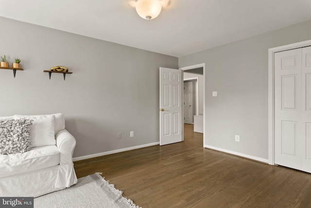 living area with baseboards and wood finished floors