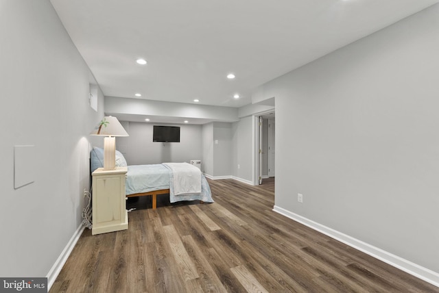 bedroom featuring baseboards, recessed lighting, and wood finished floors