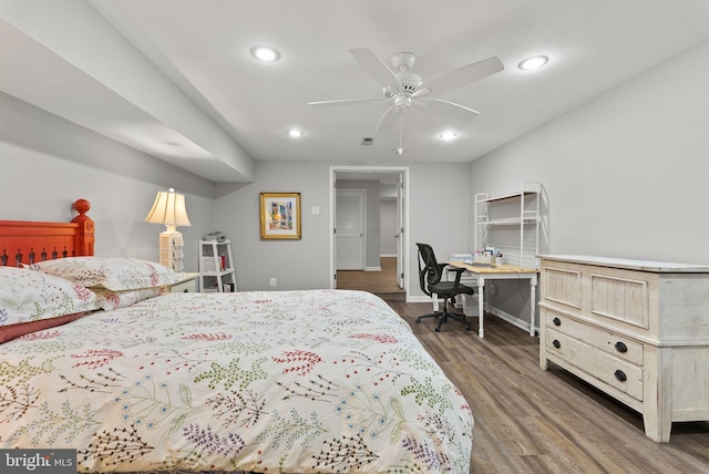 bedroom with baseboards, recessed lighting, wood finished floors, and visible vents