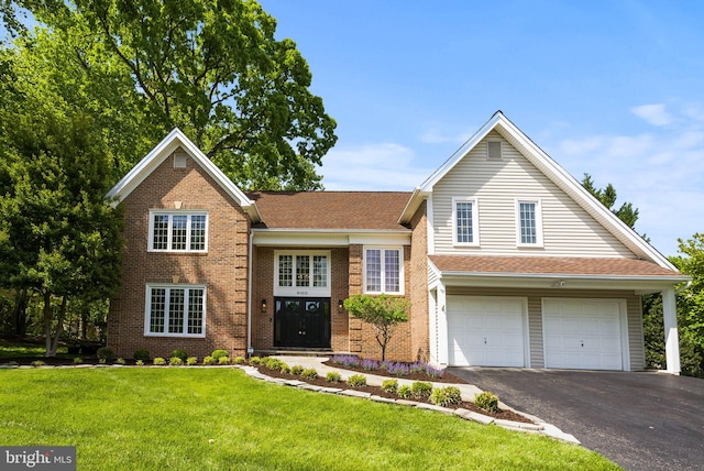 9100 Wood Spice Ln, Lorton, VA 22079 - traditional-style home featuring a garage, driveway, brick siding, and a front yard