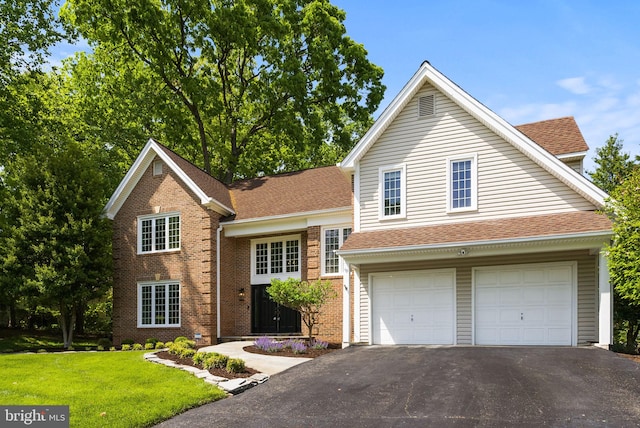 9100 Wood Spice Ln, Lorton, VA 22079 - view of front of house with aphalt driveway, a front yard, roof with shingles, brick siding, and an attached garage