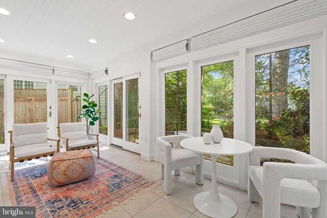 sunroom with tile patterned floors and recessed lighting