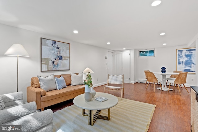 living area featuring recessed lighting, baseboards, and wood finished floors