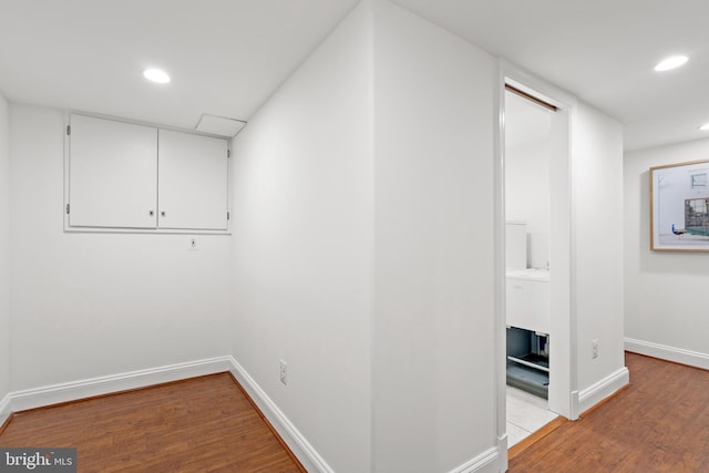 below grade area featuring recessed lighting, baseboards, and light wood-style floors