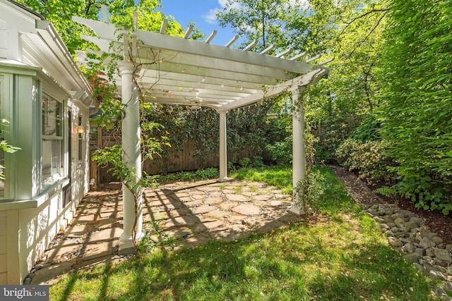 view of patio with a pergola and fence
