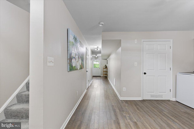 26101 Frederick Rd, Clarksburg, MD 20871 - hallway with baseboards, stairs, washer / clothes dryer, and wood finished floors