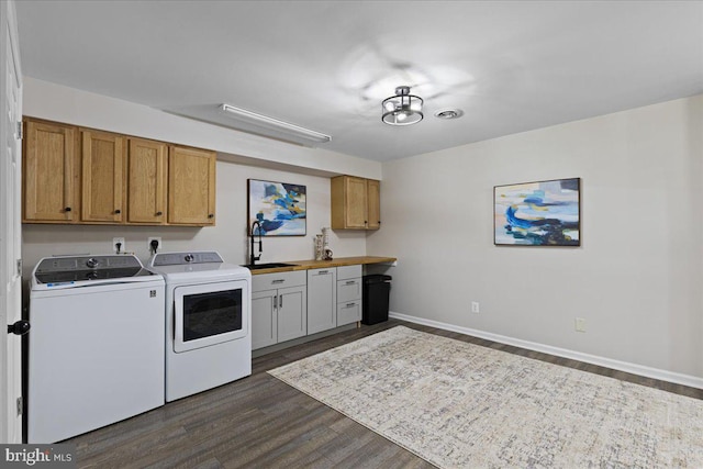 26101 Frederick Rd, Clarksburg, MD 20871 - laundry area with cabinet space, dark wood-style flooring, washing machine and dryer, and a sink