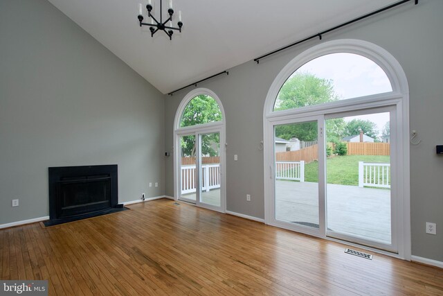 10505 Manor View Pl, Manassas, VA 20110 - unfurnished living room featuring wood-type flooring, high vaulted ceiling, visible vents, and an inviting chandelier