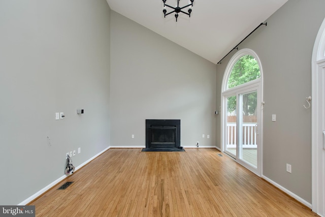 10505 Manor View Pl, Manassas, VA 20110 - unfurnished living room with visible vents, a fireplace with flush hearth, light wood-style floors, and high vaulted ceiling