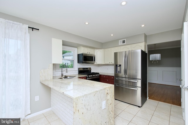 10505 Manor View Pl, Manassas, VA 20110 - kitchen featuring a sink, stainless steel appliances, a peninsula, light tile patterned floors, and visible vents