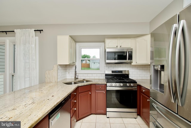 10505 Manor View Pl, Manassas, VA 20110 - kitchen with light stone countertops, a sink, stainless steel appliances, light tile patterned floors, and tasteful backsplash