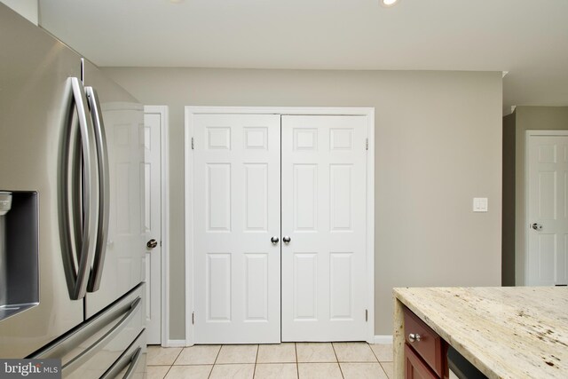 10505 Manor View Pl, Manassas, VA 20110 - kitchen with light tile patterned flooring, baseboards, light stone counters, and stainless steel fridge with ice dispenser