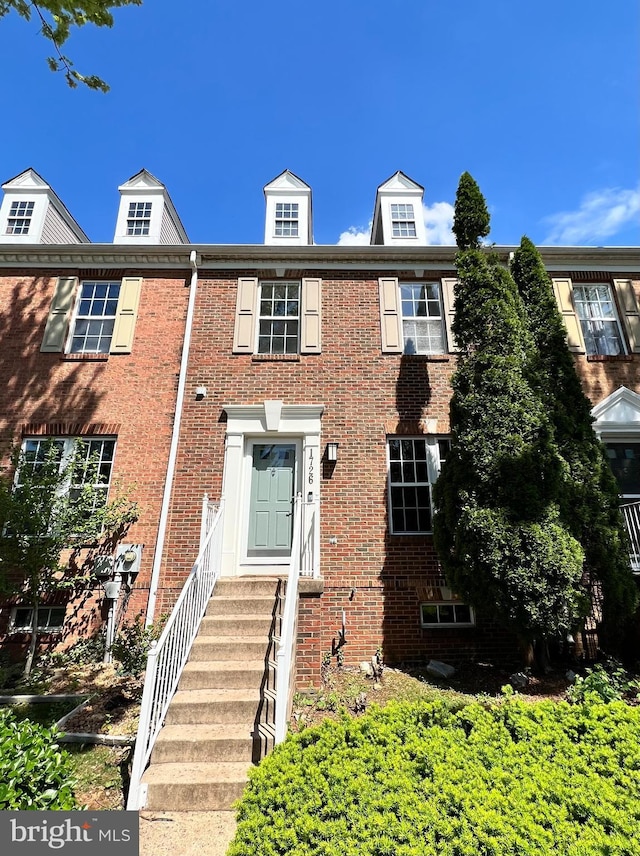 townhome / multi-family property featuring brick siding