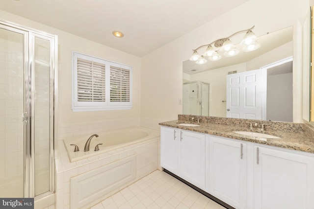 bathroom featuring a shower stall, tile patterned floors, a bath, and double vanity