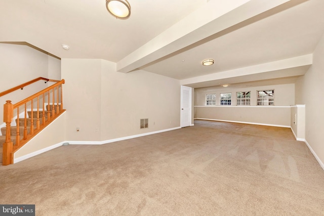 unfurnished room featuring carpet, baseboards, stairway, beam ceiling, and a smoke detector