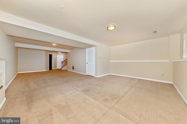 below grade area with carpet floors, baseboards, and stairs