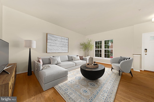 living area with light wood-style floors and baseboards