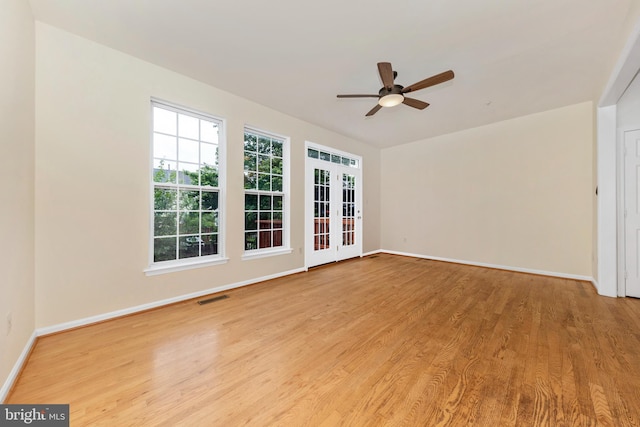 unfurnished room featuring ceiling fan, wood finished floors, and baseboards