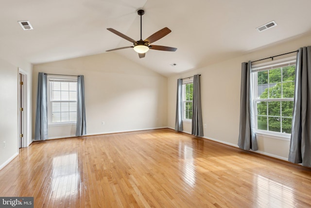 unfurnished room with ceiling fan, visible vents, light wood-style flooring, and vaulted ceiling