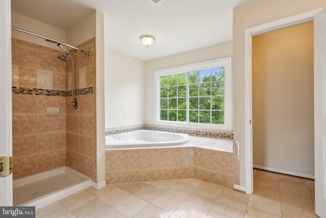 full bath featuring tile patterned floors, a tile shower, and a garden tub