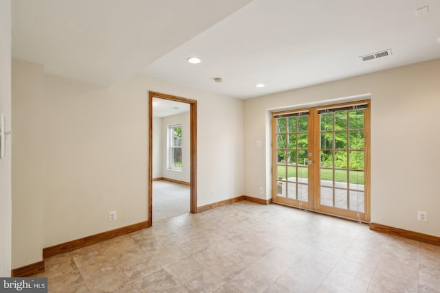 empty room with baseboards, french doors, recessed lighting, and visible vents