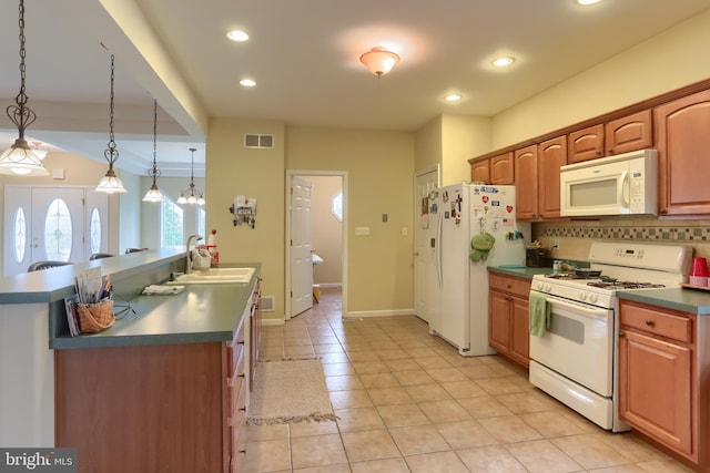2038 E Harrisburg Pike, Middletown, PA 17057 - kitchen with white appliances, light tile patterned flooring, visible vents, a sink, and dark countertops