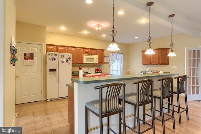 2038 E Harrisburg Pike, Middletown, PA 17057 - kitchen with a breakfast bar, dark countertops, white appliances, and pendant lighting
