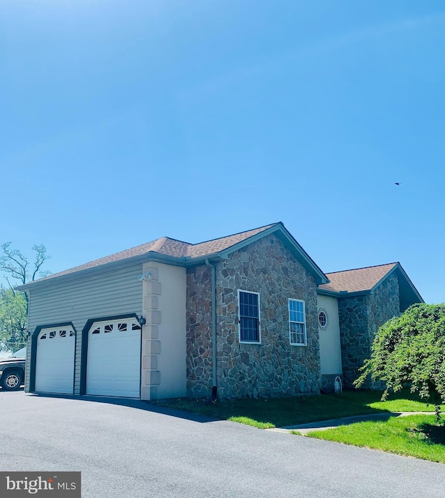 2038 E Harrisburg Pike, Middletown, PA 17057 - view of front of home with stone siding, aphalt driveway, and a garage
