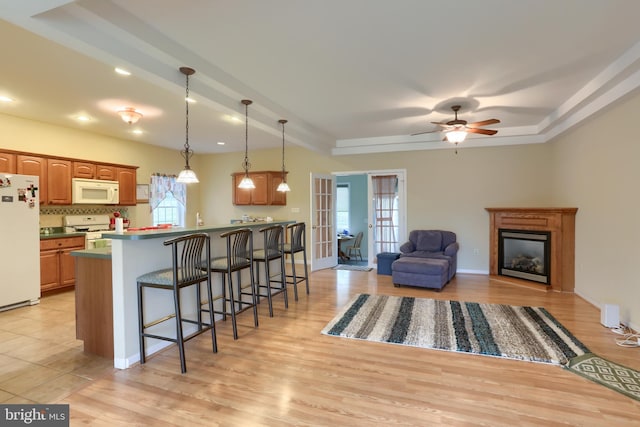 2038 E Harrisburg Pike, Middletown, PA 17057 - kitchen with pendant lighting, light wood-style flooring, white appliances, and a kitchen bar
