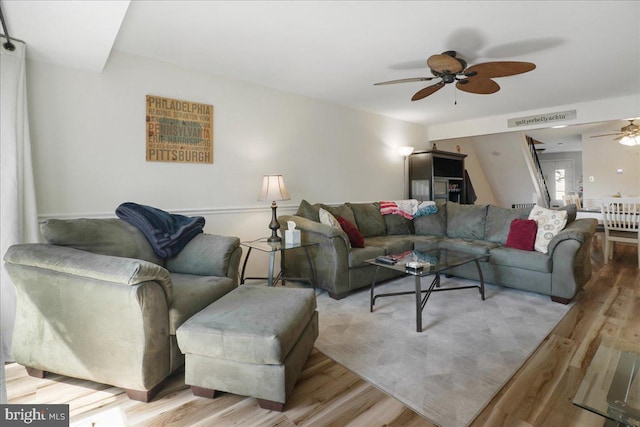 living area featuring ceiling fan and wood finished floors