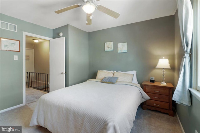 carpeted bedroom with baseboards, visible vents, and ceiling fan